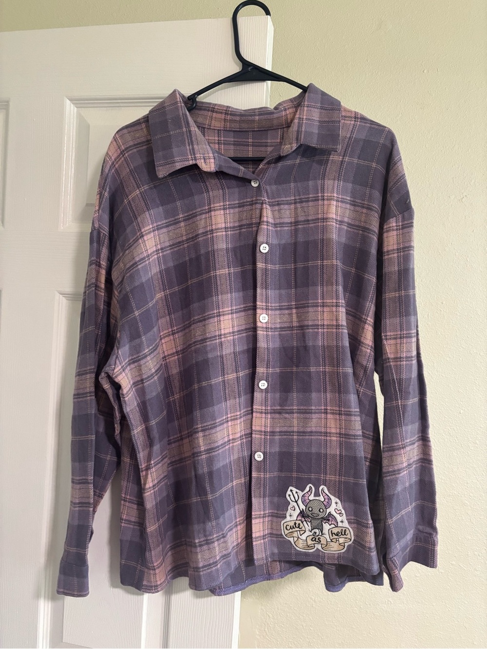 Pink and purple flannel with sewn on patch “cute as hell”